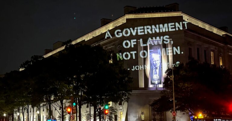 Protest Against $1.8 Billion Funding Features John Adams Quote Displayed on Justice Department Building